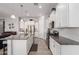 Bright kitchen featuring white cabinets, granite countertops, stainless steel appliances, and a subway tile backsplash at 10532 E Palladium Dr, Mesa, AZ 85212