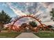 Community playground with an 'Orange Monster' structure set against a beautiful, cloudy sky at 10532 E Palladium Dr, Mesa, AZ 85212