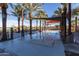 Modern community splash pad surrounded by palm trees, offering fun for all residents at 10532 E Palladium Dr, Mesa, AZ 85212