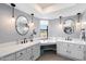 Stylish bathroom featuring dual sinks, white cabinets, pendant lighting, and a bright window at 10800 N 101St St, Scottsdale, AZ 85260