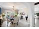 Charming dining room with a round table, arched doorway and a view into the living room at 10800 N 101St St, Scottsdale, AZ 85260