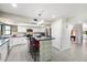 Modern kitchen featuring white cabinets, a center island with seating, and stainless steel appliances at 10800 N 101St St, Scottsdale, AZ 85260