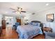 Serene main bedroom with hardwood floors, a ceiling fan, and an en-suite bathroom at 10800 N 101St St, Scottsdale, AZ 85260