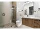 Contemporary bathroom with a glass-enclosed shower, floating vanity, and sleek black fixtures at 109 E Hayward Ave, Phoenix, AZ 85020