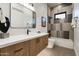 Modern bathroom featuring a floating vanity, large mirror, and stylish tile work in the shower at 109 E Hayward Ave, Phoenix, AZ 85020