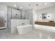 Luxurious bathroom featuring a standalone tub, walk-in shower, and modern vanity at 109 E Hayward Ave, Phoenix, AZ 85020