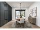 Dining area with a wooden table set with plush white chairs and modern chandelier at 109 E Hayward Ave, Phoenix, AZ 85020