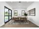 Bright dining room with a modern table and chairs, overlooking a stunning pool at 109 E Hayward Ave, Phoenix, AZ 85020