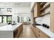 Bright open kitchen with stainless steel appliances, a large center island and hardwood floors at 109 E Hayward Ave, Phoenix, AZ 85020