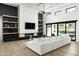 Modern living room with black accent wall, fireplace, open shelving, and hardwood floors at 109 E Hayward Ave, Phoenix, AZ 85020