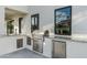 Outdoor kitchen featuring a built-in grill, sink, and stainless steel appliances at 109 E Hayward Ave, Phoenix, AZ 85020