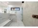 Modern walk-in shower featuring a built-in bench, mosaic tiling, and dual shower heads at 109 E Hayward Ave, Phoenix, AZ 85020