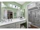 Clean bathroom featuring a vanity with dual mirrors, a toilet, and a shower with glass doors at 11010 E Keats Ave, Mesa, AZ 85209