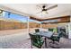 This inviting covered patio showcases a dining set, privacy shades and is perfect for enjoying the backyard at 11010 E Keats Ave, Mesa, AZ 85209