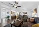 Spacious living room featuring a ceiling fan, hardwood floors, comfortable seating, and an open floorplan at 11010 E Keats Ave, Mesa, AZ 85209