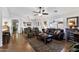 Open-concept living room with wood floors, ceiling fan, comfortable seating and seamless flow to dining area at 11010 E Keats Ave, Mesa, AZ 85209