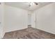 Neutral bedroom with carpeting features a ceiling fan and white painted door at 11918 W Yearling Ct, Peoria, AZ 85383