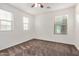 Bedroom with carpet, ceiling fan, and bright natural light from large windows at 11918 W Yearling Ct, Peoria, AZ 85383