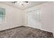 Neutral bedroom features a ceiling fan, carpeting and a closet with sliding doors at 11918 W Yearling Ct, Peoria, AZ 85383