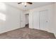 Bedroom with plush carpeting, ceiling fan, closet and white painted door at 11918 W Yearling Ct, Peoria, AZ 85383