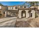 Inviting home exterior with a two-car garage, covered porch, and meticulously landscaped front yard at 11918 W Yearling Ct, Peoria, AZ 85383