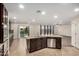 Open concept kitchen featuring dark wood cabinets, granite countertops, and stainless steel appliances at 11918 W Yearling Ct, Peoria, AZ 85383