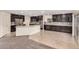 Modern eat-in kitchen featuring dark cabinets, stainless steel appliances, and stylish tile flooring at 11918 W Yearling Ct, Peoria, AZ 85383