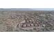 A wide aerial view shows the community of homes nestled in the valley with mountain views at 12008 S 186Th Dr, Goodyear, AZ 85338