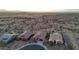 Scenic aerial view of desert homes with tile roofs in a planned community with mountain views at 12008 S 186Th Dr, Goodyear, AZ 85338