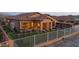 Inviting backyard with pergola, outdoor kitchen, cozy seating, and manicured turf for outdoor enjoyment at 12008 S 186Th Dr, Goodyear, AZ 85338