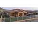 Private fenced backyard with a patio, grill area, grass, and desert scenery at 12008 S 186Th Dr, Goodyear, AZ 85338