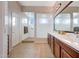 Well-appointed bathroom with a glass shower, dual sinks, and stylish tile flooring at 12008 S 186Th Dr, Goodyear, AZ 85338