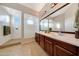 Bright bathroom with dual sinks, a walk-in shower, and neutral decor for a spa-like feel at 12008 S 186Th Dr, Goodyear, AZ 85338