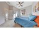 Bedroom featuring carpet flooring, a ceiling fan, and a window with backyard view at 12008 S 186Th Dr, Goodyear, AZ 85338