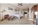 Cozy bedroom featuring tile flooring, natural light, and a comfortable seating area with a view to an office space at 12008 S 186Th Dr, Goodyear, AZ 85338