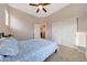 Cozy bedroom with neutral walls, carpet flooring, double-door closets, and a ceiling fan at 12008 S 186Th Dr, Goodyear, AZ 85338