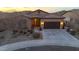 Inviting single-story home with a tile roof, desert landscaping, and an attached two-car garage at sunset at 12008 S 186Th Dr, Goodyear, AZ 85338