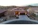 Exterior front view of a well-maintained home with a landscaped yard and three-car garage at 12008 S 186Th Dr, Goodyear, AZ 85338