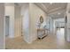 Bright hallway with tile floors, stylish console table, decorative mirror, and views into the dining area at 12008 S 186Th Dr, Goodyear, AZ 85338