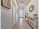 Welcoming hallway featuring tile floors, console table, a decorative mirror, and a modern front door at 12008 S 186Th Dr, Goodyear, AZ 85338