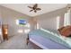 Well-lit main bedroom showcasing neutral walls, carpet, and ceiling fan at 12008 S 186Th Dr, Goodyear, AZ 85338