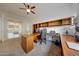 Functional home office with built-in desk and shelving, ideal for working from home with a view to the backyard at 12008 S 186Th Dr, Goodyear, AZ 85338