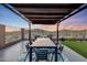 Charming outdoor dining area with mountain views and shaded pergola, perfect for entertaining at 12008 S 186Th Dr, Goodyear, AZ 85338