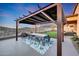 Outdoor dining area with a stylish pergola, providing shade and mountain views at 12008 S 186Th Dr, Goodyear, AZ 85338