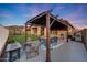 Outdoor dining area with a stylish pergola, ideal for entertaining guests at 12008 S 186Th Dr, Goodyear, AZ 85338