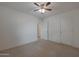 Spacious bedroom featuring plush carpet, ceiling fan, and ensuite entrance at 1257 N 166Th Ave, Goodyear, AZ 85338