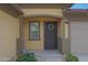 Inviting front entrance featuring a secure screen door and a lovely decorative wreath at 1257 N 166Th Ave, Goodyear, AZ 85338