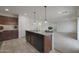 Modern kitchen featuring granite countertops, stainless steel sink, and pendant lighting at 1257 N 166Th Ave, Goodyear, AZ 85338