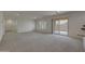 Bright living room featuring plush carpeting, natural light, and access to the outdoor space at 1257 N 166Th Ave, Goodyear, AZ 85338