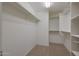 Spacious walk-in closet with shelves and metal hanging rods at 1257 N 166Th Ave, Goodyear, AZ 85338